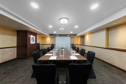 a large conference room with a long table and chairs at Citymax Sharjah in Sharjah