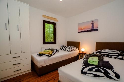 a bedroom with two beds and a lighthouse at Lee house, WI-FI,FREE PARKING, HOT TUBE in Peroj