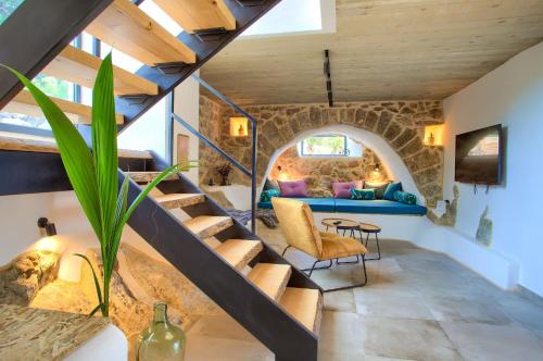 a staircase in a house with a stone wall at Villa MAY in Gostinjac