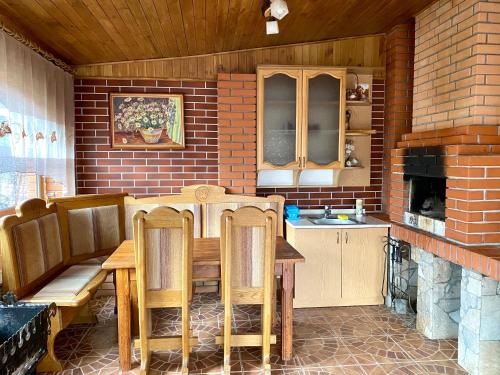 a kitchen with a wooden table and chairs in a room at Guest house Mountain View in Polyana