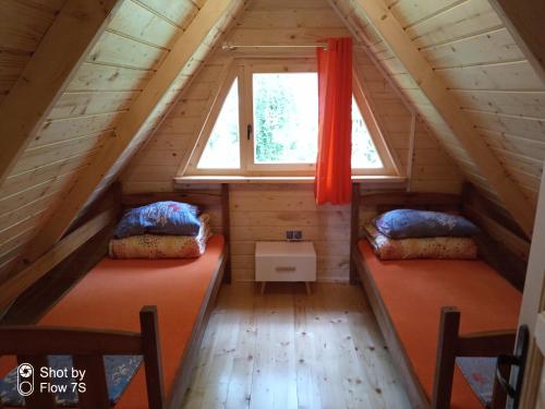 two beds in the attic of a tiny house at Sławska Poręba in Sława