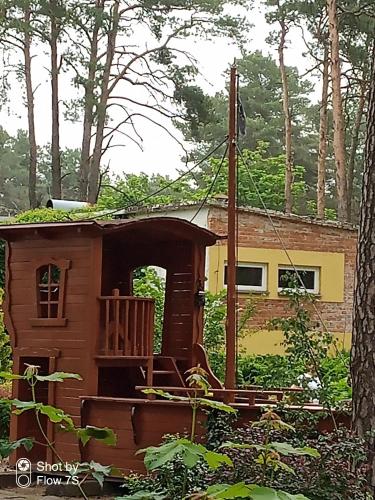a tree house with a porch in the woods at Sławska Poręba in Sława