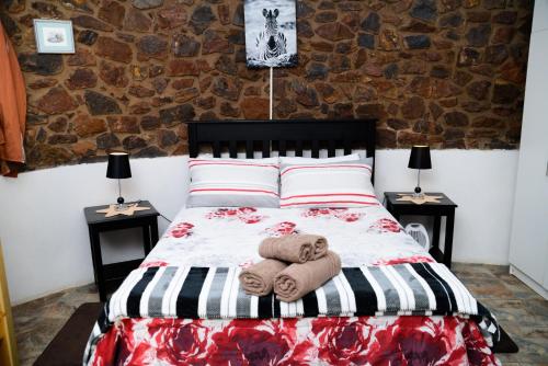 a bedroom with a bed with towels on it at Shala Mushe Tented Camp & Camp in Bela-Bela