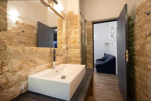 a bathroom with a white sink and a mirror at Résidence U LATONU - Palombaggia in Porto-Vecchio