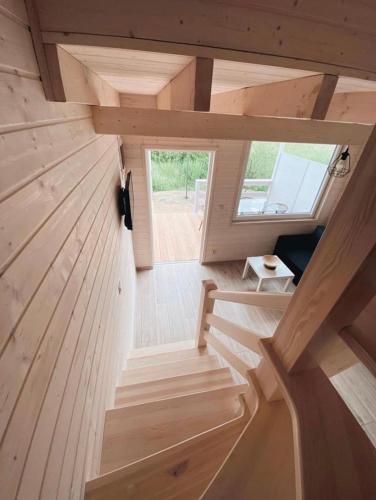 a tiny house with a staircase in the middle at Nad Rozlewiskiem in Bobolin