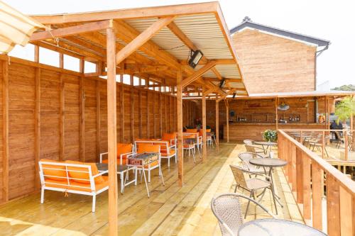 a restaurant with wooden walls and tables and chairs at MARINE-Q in Inami