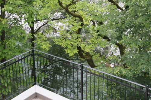 a wrought iron staircase in a park with trees at Apartments Jez in Slappe dʼIdria