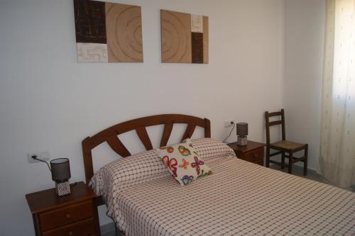 a bedroom with a bed with a pillow on it at Apartamentos Porta Mediterranea in Alcossebre