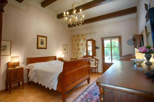 a bedroom with a bed and a table in it at La Renaia in Cortona