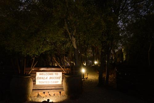a sign that says welcome to wild music transfer center at night at Shala Mushe Tented Camp & Camp in Bela-Bela
