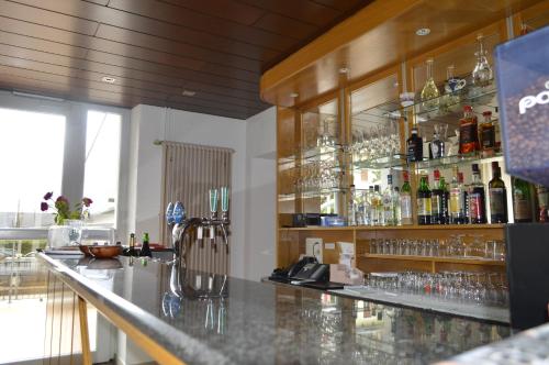 a bar with a lot of bottles and glasses at Albergo Svizzero in Biasca