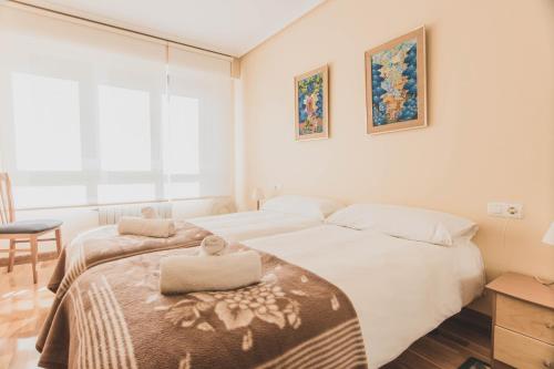 a bedroom with a bed with a towel on it at Arriola - Local Rentss in San Sebastián