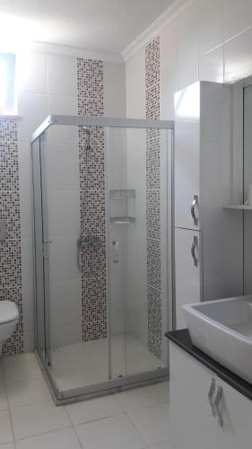 a bathroom with a glass shower and a sink at Rota Villalari in Dalyan