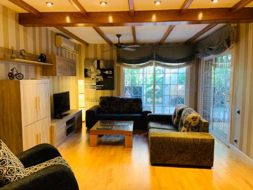 a living room with two couches and a coffee table at Casa Cambrils Bahia in Cambrils
