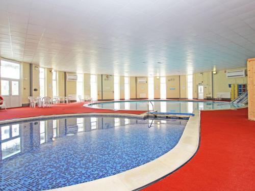 a large swimming pool in a large building at Little Jack's in Callington