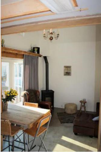 a living room with a bed and a fireplace at Have a nice stay! - Beach Cottage free parking in Noordwijk aan Zee
