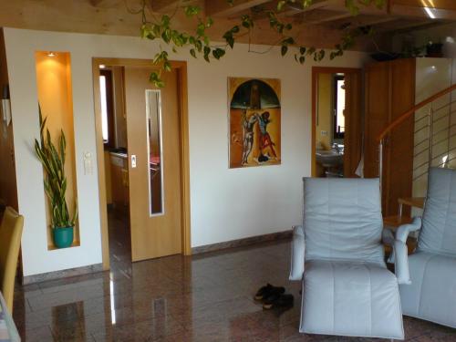 a living room with two chairs and a table at Studio A Am Burgberg in Erlangen