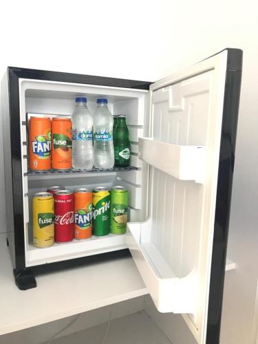 an open refrigerator filled with bottles of water and soda at Rota Hotel in Dalyan
