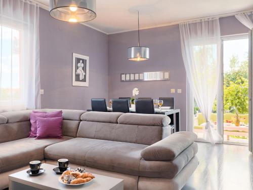 a living room with a couch and a table at Holiday Home Neja by Interhome in Loborika