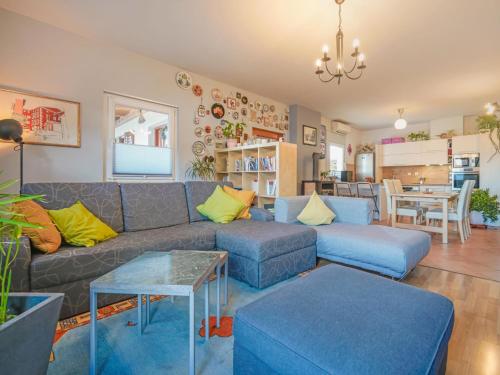 a living room with a couch and a table at Holiday Home Villa More by Interhome in Lovran