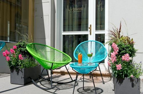 
a green lawn chair sitting in front of a patio at Hotel Beethoven Wien in Vienna
