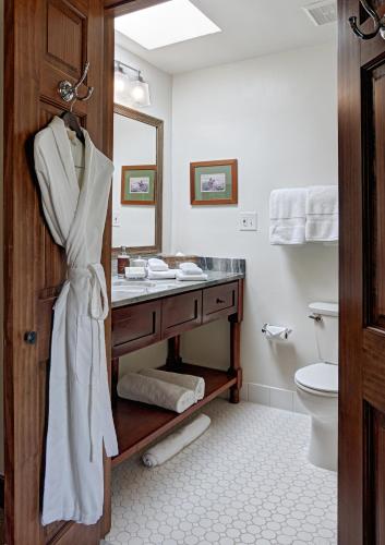 a white bathroom with a sink and a toilet at The Hermosa Inn in Phoenix