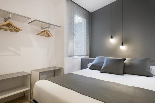 a bedroom with a white bed and a window at Ola Living Santa Anna in Barcelona