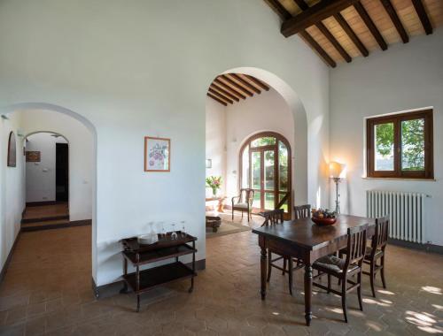 a living room with a wooden table and chairs at Fonte Sala in Montefalco