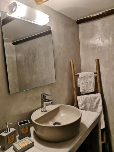 a bathroom with a sink and a mirror at Relax Seaside House by living in blue in Haraki