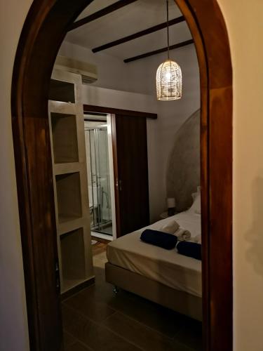 a bedroom with a bed and a mirror at Relax Seaside House by living in blue in Haraki