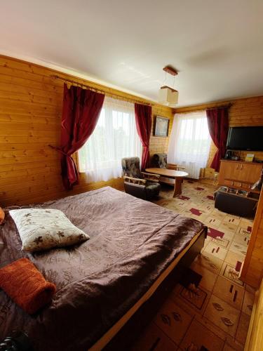 a bedroom with a large bed in a room at Willa Światowid in Rabka-Zdrój