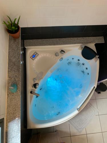 a bath tub with a blue inside of it at Ti Macoua Studio bord de mer in Saint-Pierre