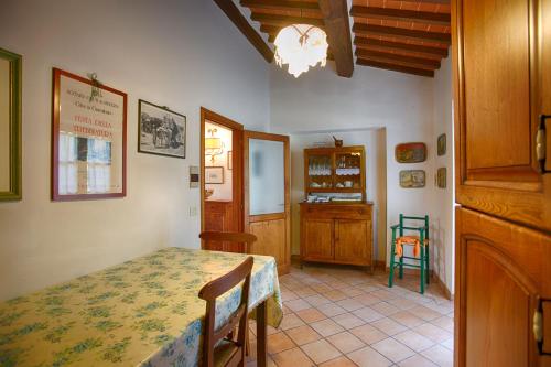 a dining room with a table and a chair at La Renaia in Cortona