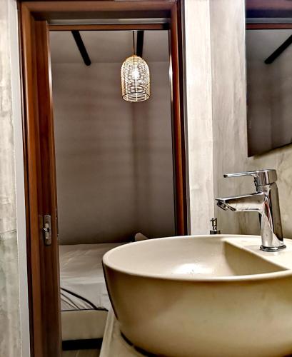 a bathroom with a sink and a mirror at Relax Seaside House by living in blue in Haraki