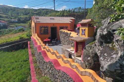 a train yard with a building on a hill at Casa Boa Onda in Lajes das Flores