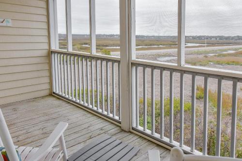 a porch with two chairs and two windows at The Sunset Inn in Sunset Beach