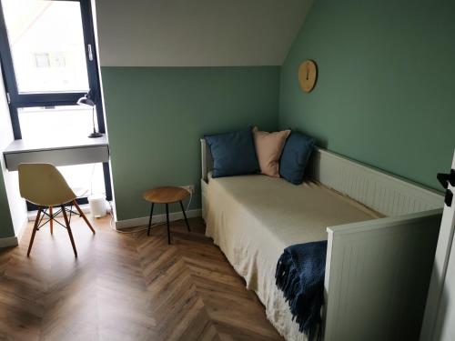 a bedroom with a bed and a clock on the wall at Trident Apartment III in Gdańsk
