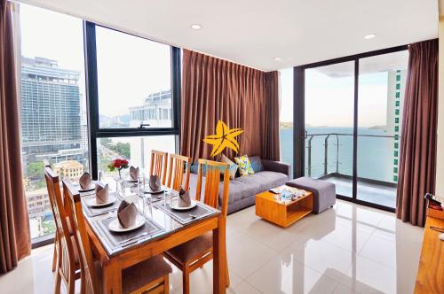 a living room with a table and a couch at Holi Beach Hotel & Apartments in Nha Trang