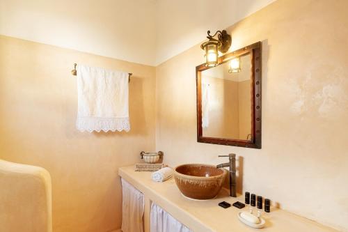 a bathroom with a sink and a mirror at Traditional Cretan House Lithostrati Karidi Village in Karídhion