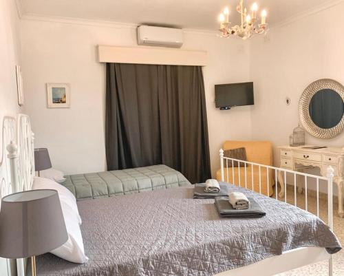 a bedroom with a bed and a chair and a mirror at Villa Zammitella in St Paul's Bay