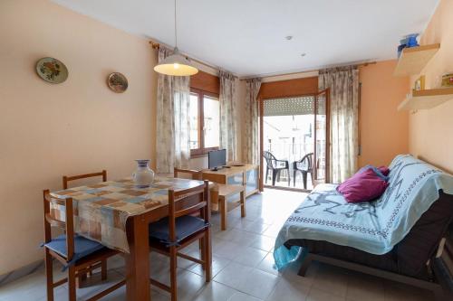 a bedroom with a table and a bed and a desk at PORT I Sistach Rentals in L'Estartit