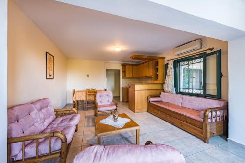 Sala de estar con 2 sofás y mesa en Small Village Residences, en Akrotiri