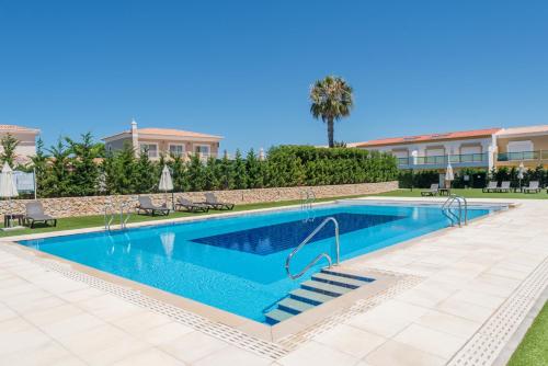 a swimming pool with blue water in a resort at Boavista Resort - Casa Belinda in Lagos