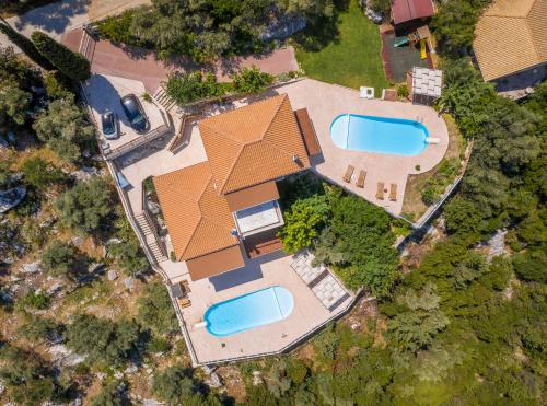 an overhead view of a house with two swimming pools at Violitzis Villas in Neokhórion