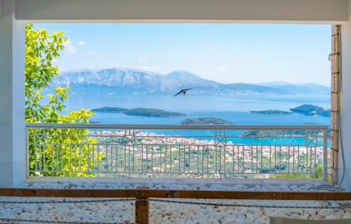 a large window with a view of the water at Violitzis Villas in Neokhórion