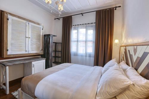 a bedroom with a large bed and a window at Trilye Bay C Konak in Bursa