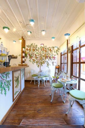 a restaurant with tables and chairs in a room at Trilye Bay C Konak in Bursa