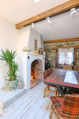 a living room with a table and a fireplace at Trilye Bay C Konak in Bursa