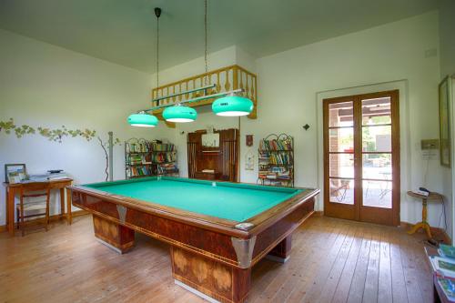 a pool table in the middle of a room at La Renaia in Cortona