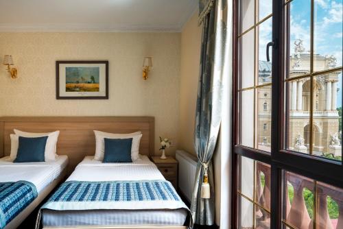 a hotel room with a bed and a window at Mozart Hotel in Odesa